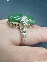 Profile view showing jade cabochon and snake motif