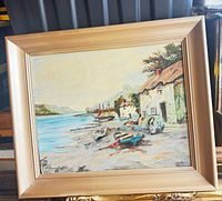 Full view of framed coastal village painting