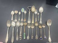 All 22 pieces laid out showing variety of spoons and bottle opener