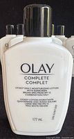 Front view showing Olay Complete bottle and additional identical bottles behind