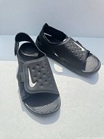 Overall view of both black Nike Sunray Adjust 5 V2 sandals