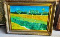 Full view of framed painting showing landscape scene and ornate gold frame