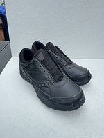Pair of black Saucony Cohesion 13 LTT sneakers side view