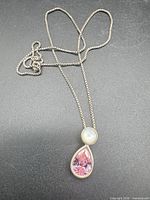 Full view of necklace laid flat showing chain length and pendant