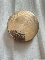 Closed compact showing engraved lid design