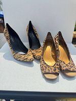 Both pairs of animal-print heels side by side
