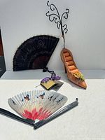 All items together: two folding fans and padded shoe ring holder