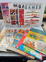 Front view of entire stack showing multiple Games issues and Cartoons & Gags