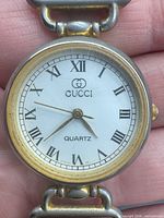 Front view showing dial, logo, and two-tone case