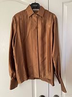 Front view of bronze silk satin Jaeger blouse on hanger, showing pintuck pleats and overall condition