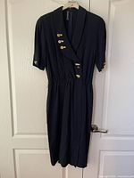 Front view showing shawl lapel, gold buttons, elastic waist