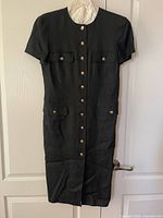Front view of dress showing buttons and pockets