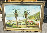 Framed oil painting landscape with two palm trees, sea, hillside, cityscape