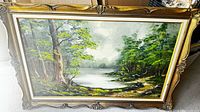 Front view of framed woodland landscape painting