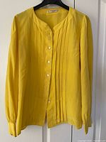 Front view showing color, band collar, pintuck pleats and buttons