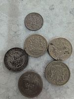 Obverse and reverse views of six of the coins showing size and metal tones