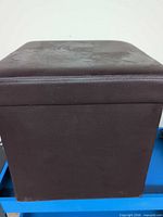 Side view of brown faux leather cube ottoman