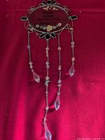 Full view of suncatcher showing plaque, hanging chains and crystal drops