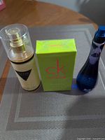 Group shot of three fragrances: CK One Summer box, Guess bottle, Blue Dream bottle