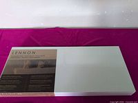 Sealed white IKEA Lennon shelf box on table