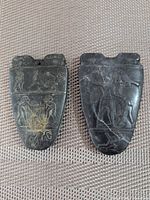 Front view showing both carved pendants and details of incised imagery