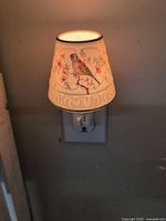 Porcelain bird and floral night light plugged in