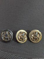 Front view of three eagle motif buttons