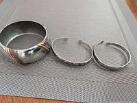 Group shot of wide bangle and two narrow cuffs