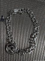 Full view of sterling bracelet showing chain, charms and clasp