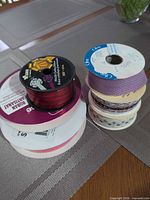 Stacked ribbon spools showing mixed colours and widths
