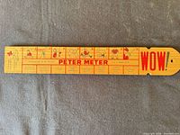 Front of wooden novelty ruler showing full printed scale and WOW text