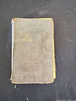 Front cover of worn cloth hardcover Holy Bible