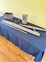 Overall lot showing hand brace, Fly Chaser tin, wooden crate, wood boards and ruler