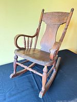 Front three-quarter view of wooden child's rocking chair