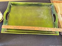 green wooden tray with ruler for scale