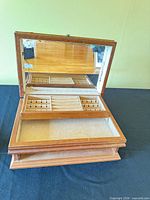 Open jewelry box showing mirror, removable tray, interior lining