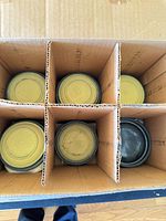 Top view of six compartments each holding yellow/tan clay targets