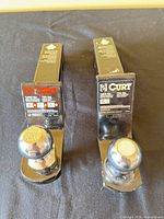 Two CURT ball mounts side by side showing overall condition and attached tow balls