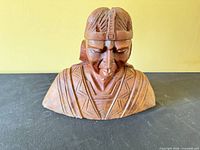 Front angled view of carved wooden bust