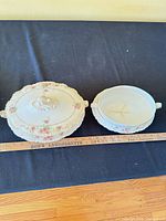 Covered serving dish with lid beside base, ruler for scale