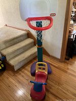 Full view of basketball hoop with ride-on attached at base
