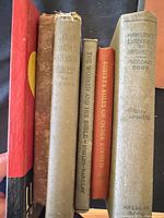 Five hardcover and softcover book spines for identification