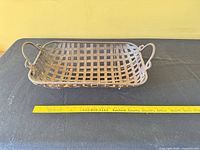 Angled view of entire metal tray showing handles and ruler for scale