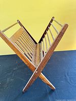 Magazine rack open, side view showing V-shape and slatted design