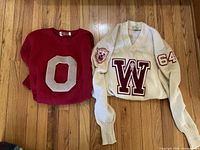 Both sweaters side by side displaying front patches and overall condition