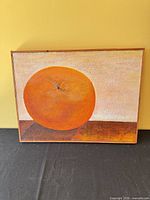 Front view of oil painting showing orange fruit still life