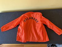 Full back view showing orange jacket and "DELAWARE" text