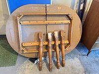 Tabletop underside with rails and four detached legs