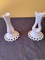 Front view of both milk glass bud vases