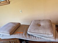 Bench and square cushions showing fabric, color, and wear